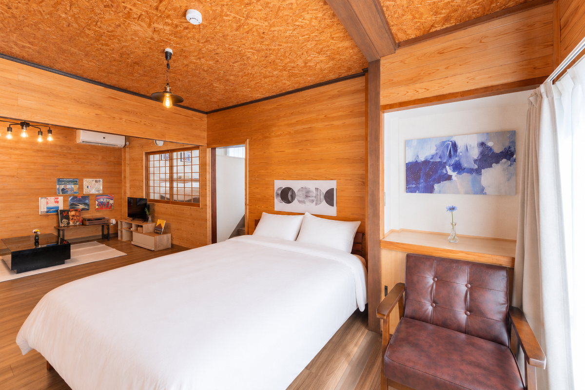 The timber-lined bedroom and a leather chair