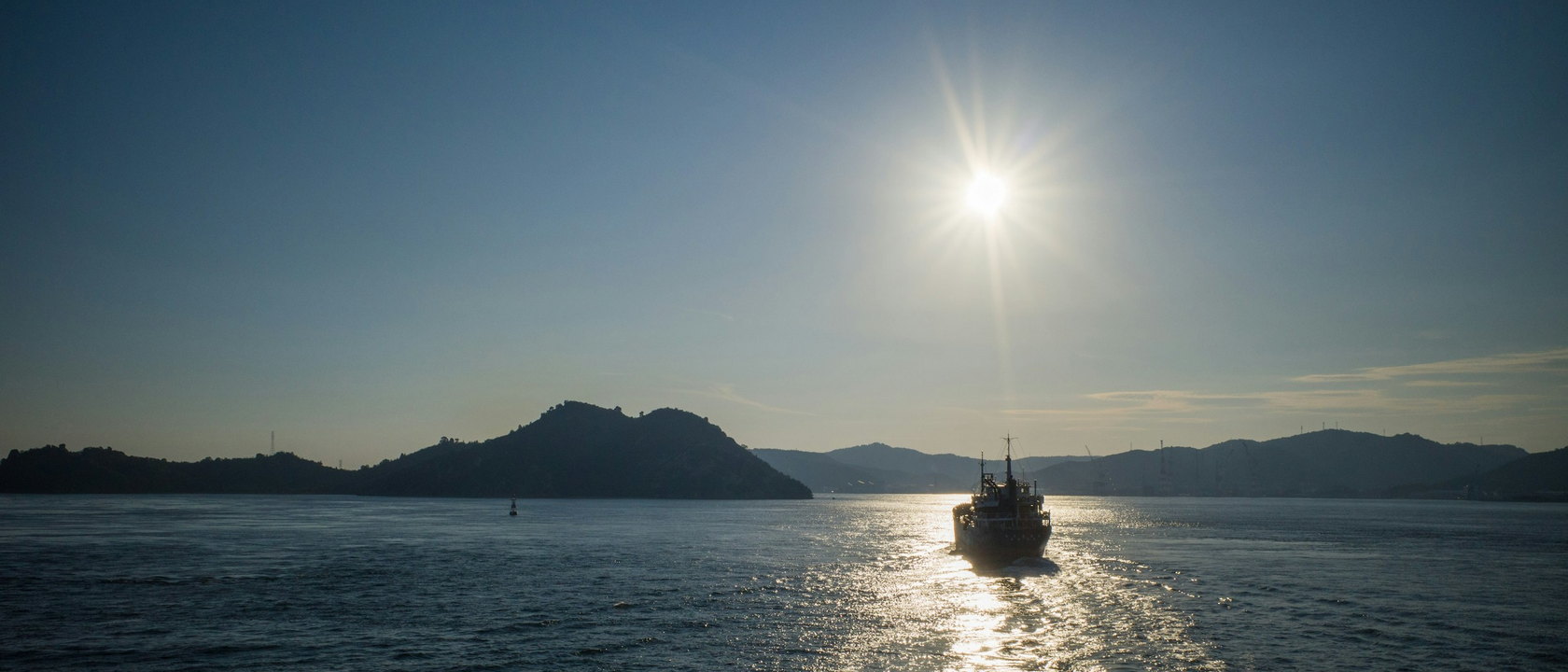 The Seto Inland Sea at dusk with a boat returning to port